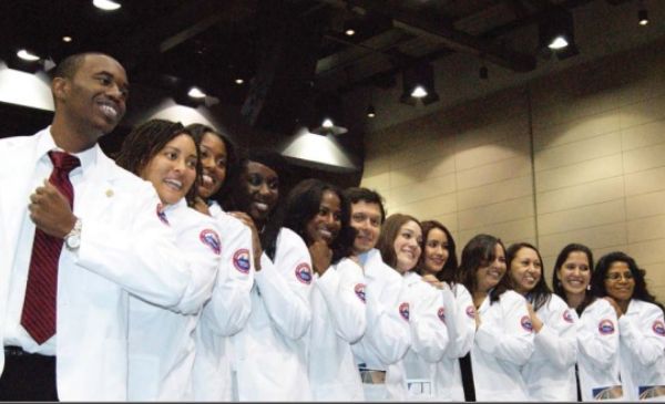 UIC College of Medicine students pose for a photo with their white coats.
